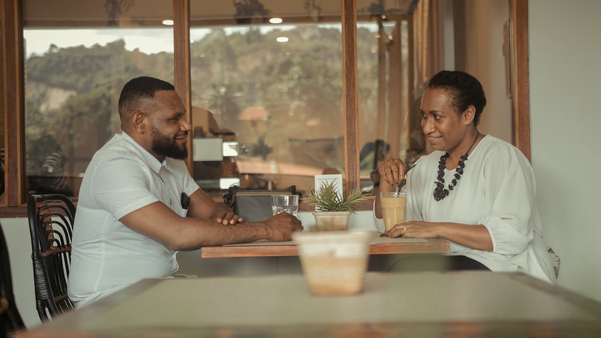 African couple having a serious face to face conversation