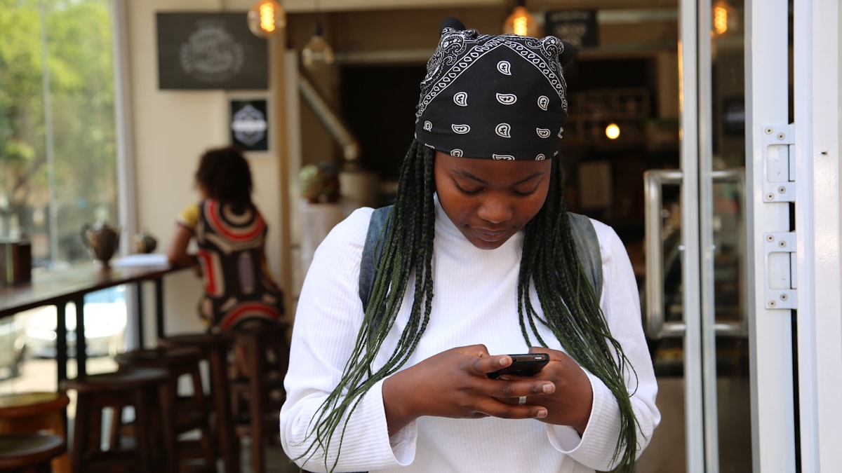 African woman checking her mobile money on her phone