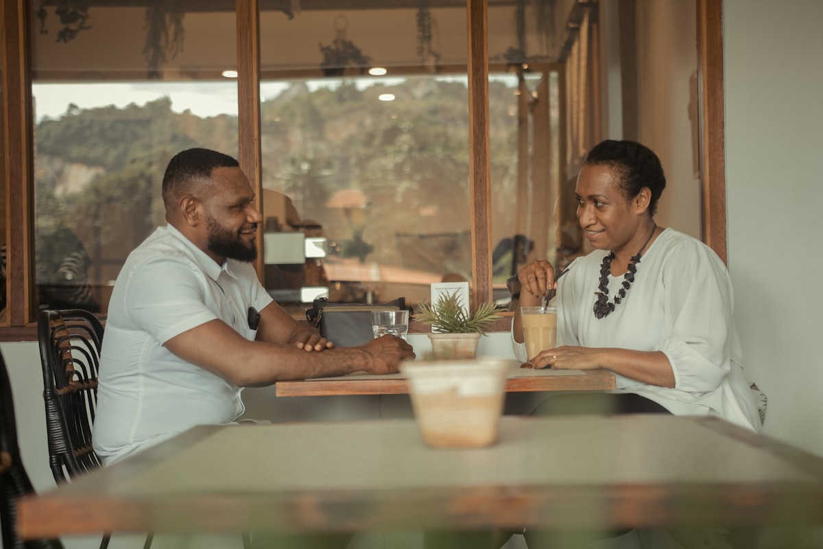 African couple in a serious money conversation at a table