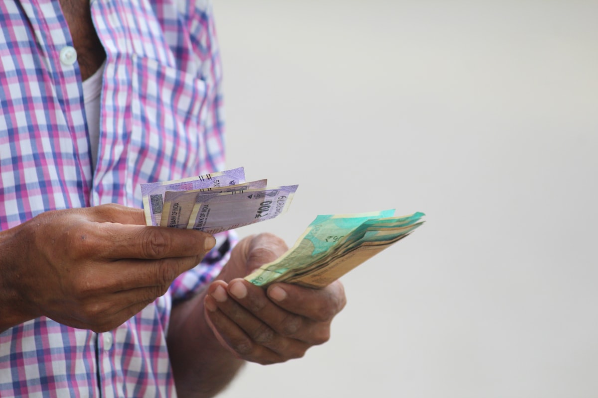 African hands counting cash banknotes